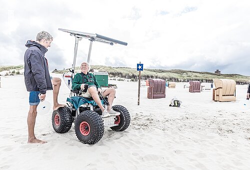 Solarbetriebener Rollstuhl am Juister Strand für barrierearmes Reisen an der Nordsee