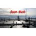 Logo Buchhandlung Koch - Foto Hafen mit roter Schrift oben "Juist-Buch"